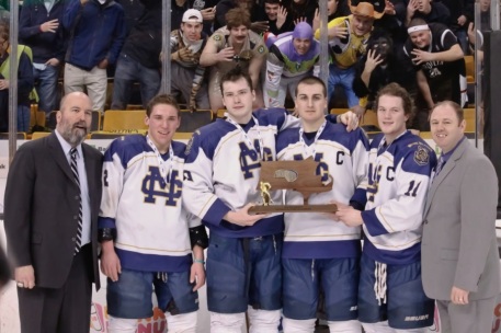 Coach John McLean & Athletic DIrector Patrick Driscoll accept the Championship trophy with their team captains.